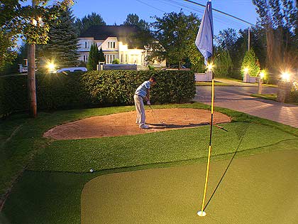 The son of a Putters Edge dealer works on his sand wedge, using the putting green practice facility that convinced his father to join Putters Edge as an Authorized Dealer!